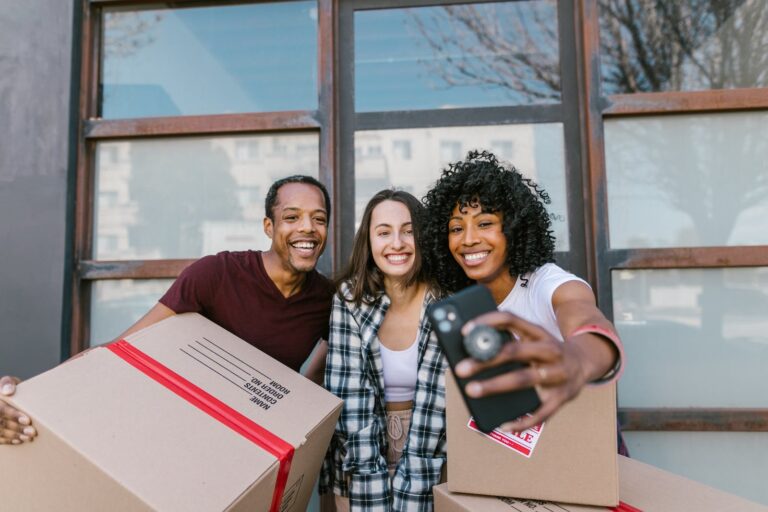 Man and Woman Smiling While Holding Box